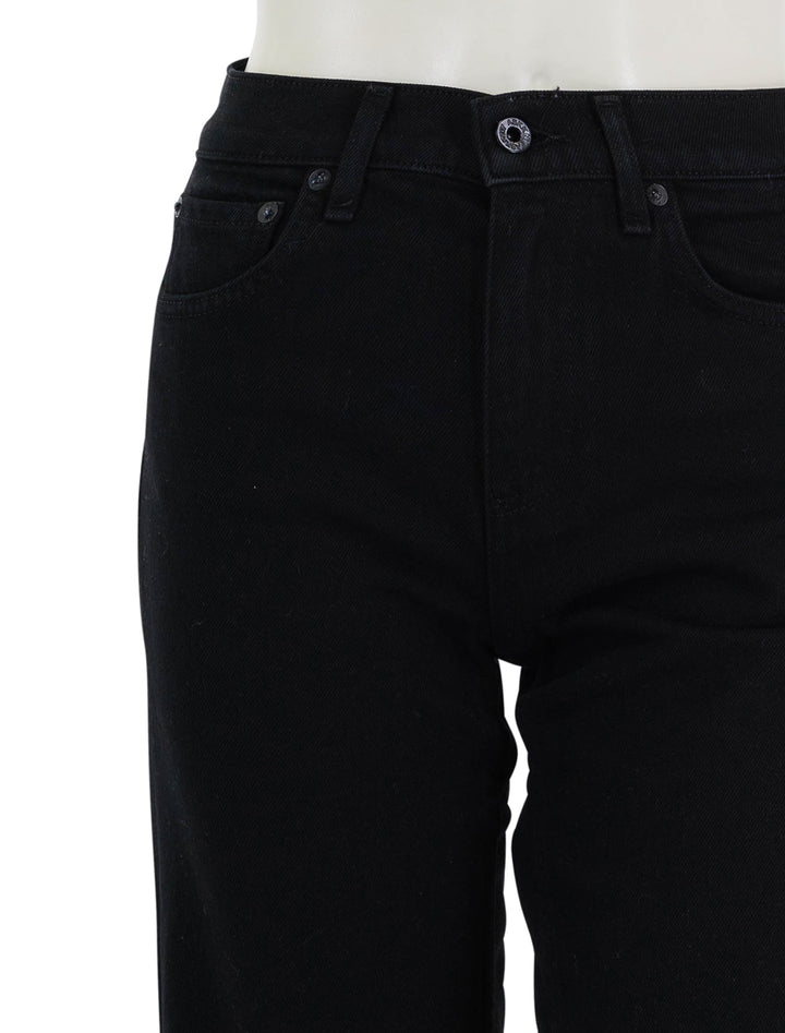 close up view of slim crop black resin jeans