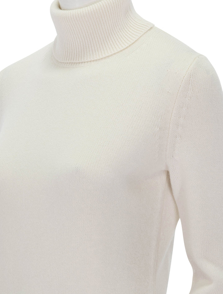 Close-up view of Theory's classic cashmere turtleneck in ivory.