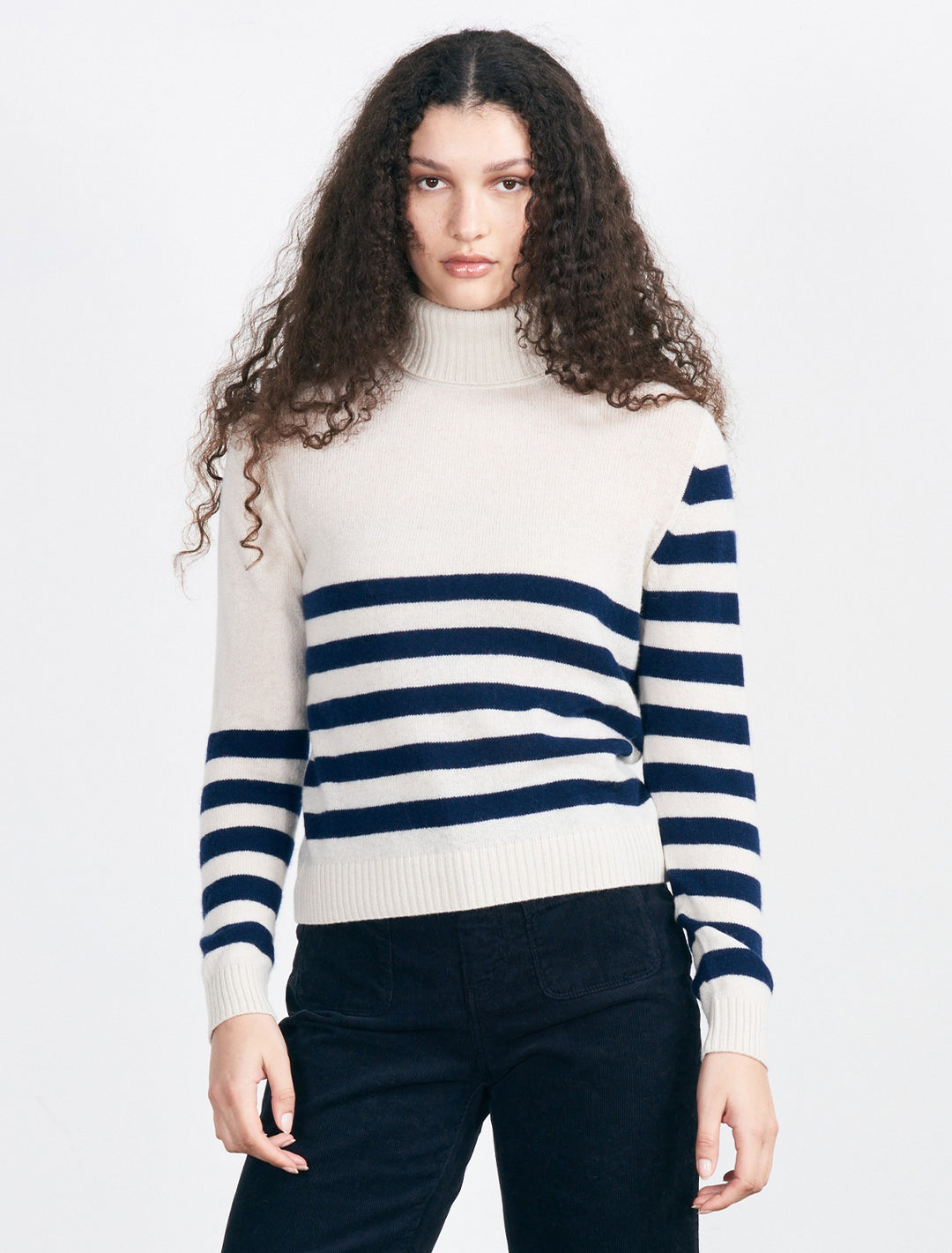 Model wearing Jumper 1234's Invert Stripe Roll Collar in Jasmine and Shark.