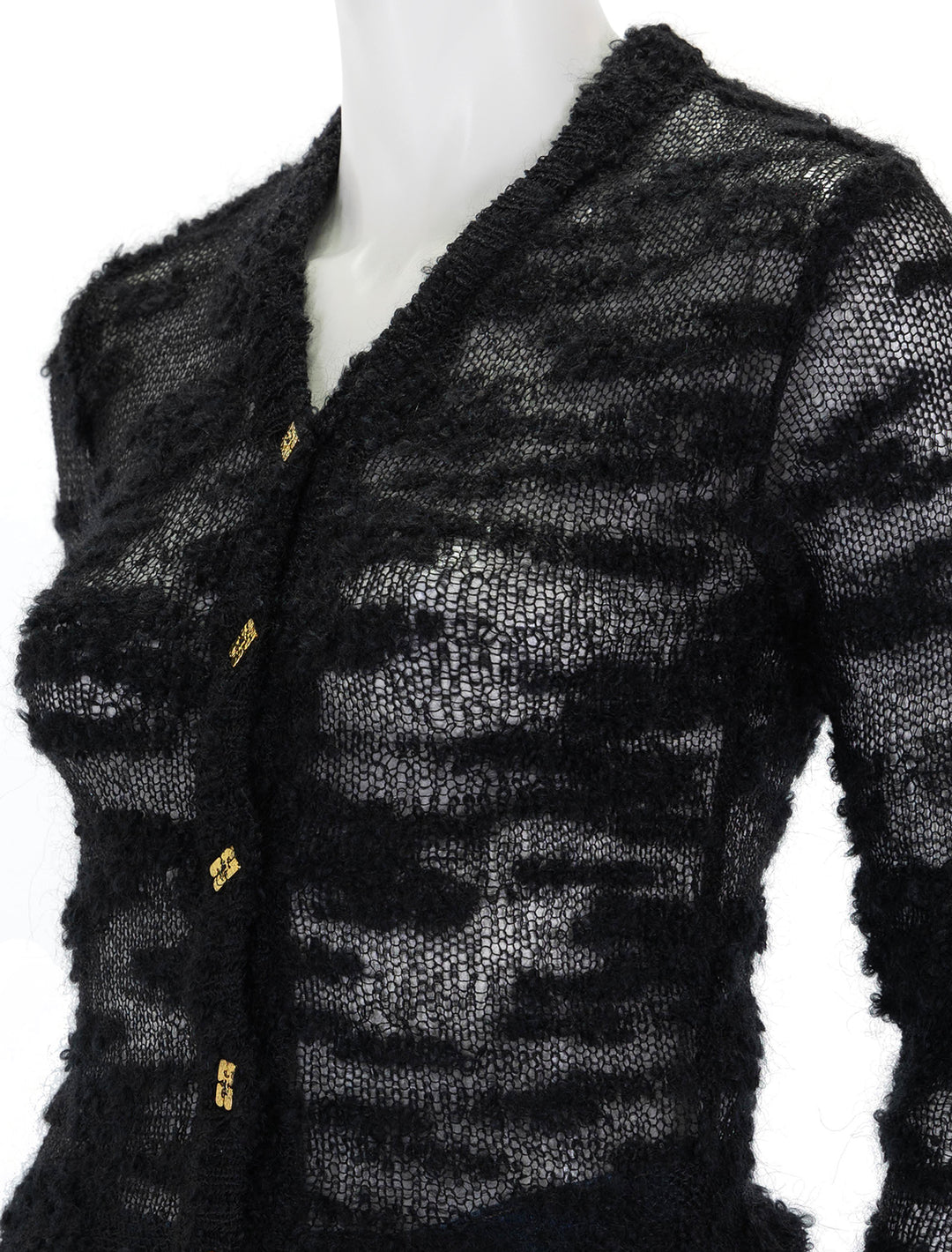 Close-up view of GANNI's boucle cardigan in black.