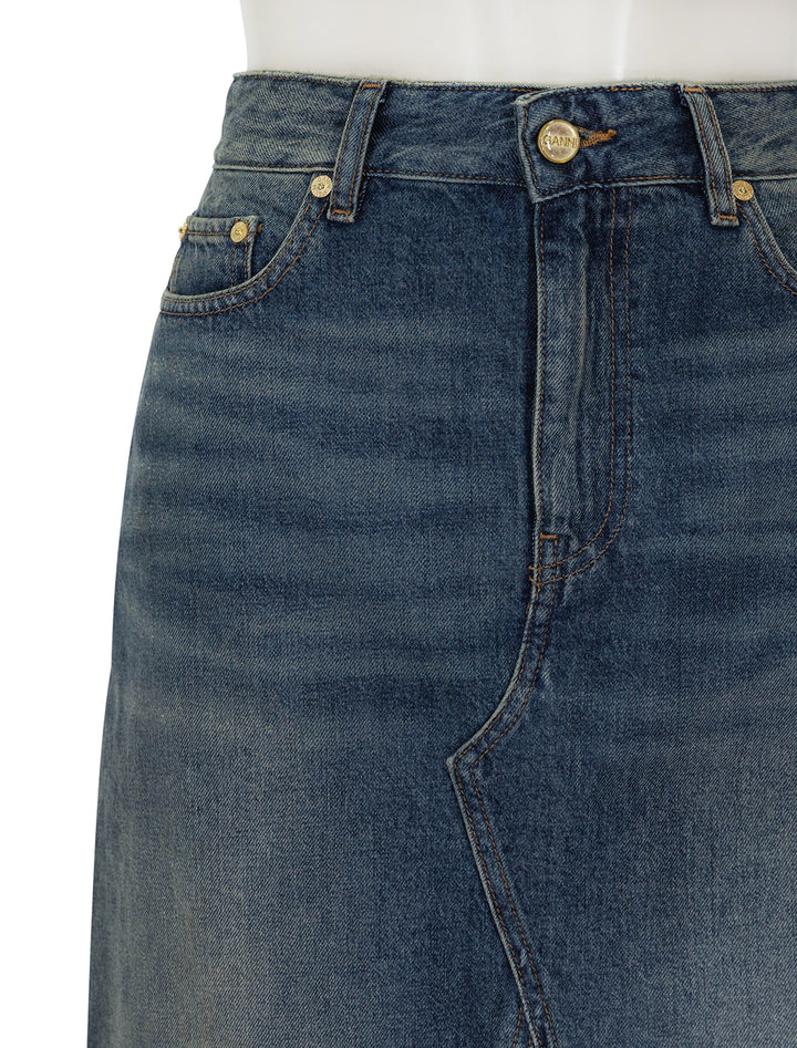 Close-up view of GANNI's denim midi skirt in mid blue vintage.