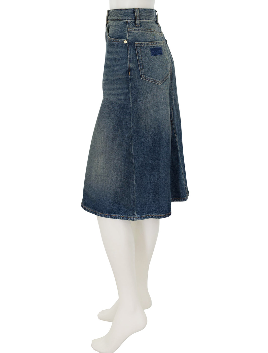 Side view of GANNI's denim midi skirt in mid blue vintage.