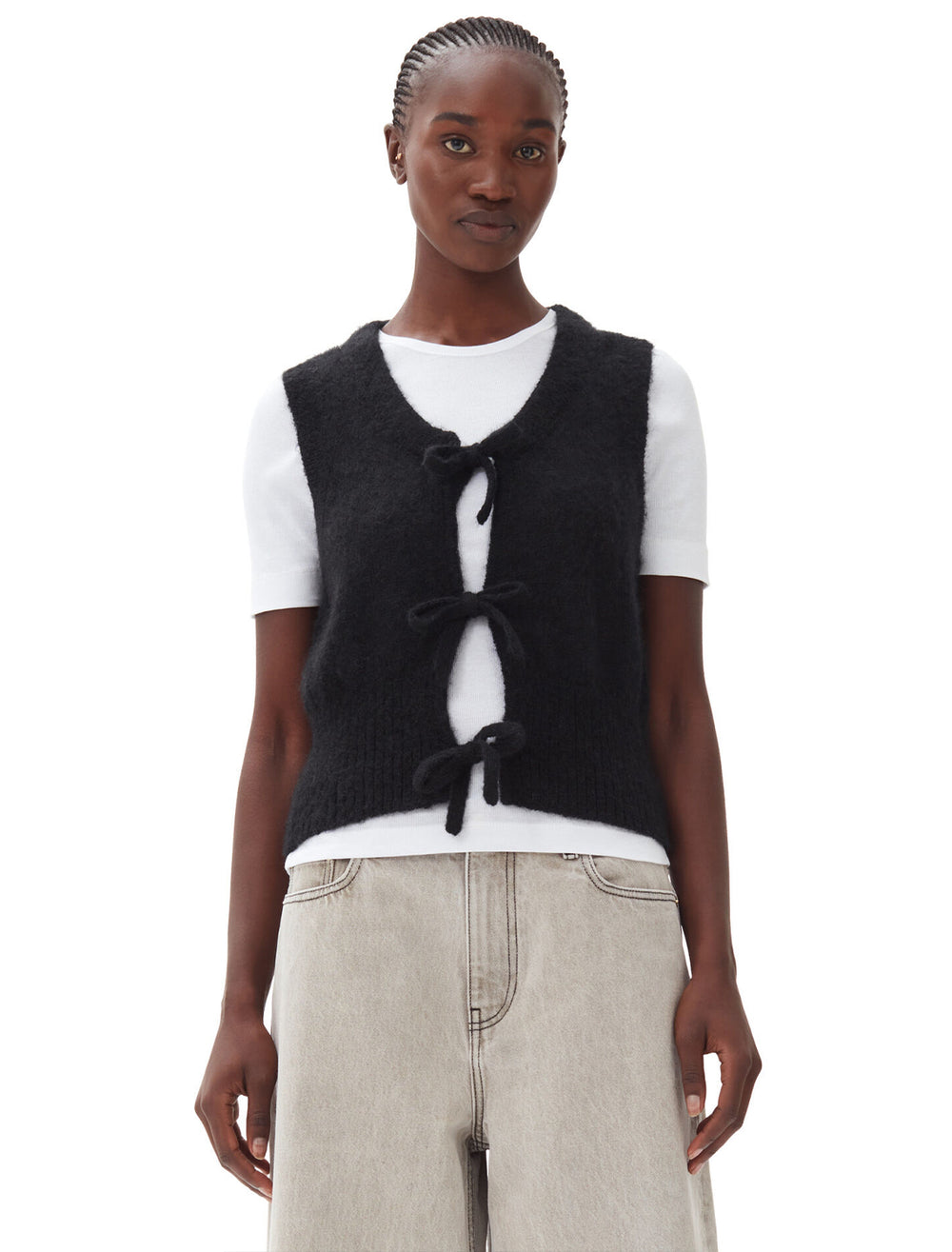 Model wearing Ganni's tie string vest in black.