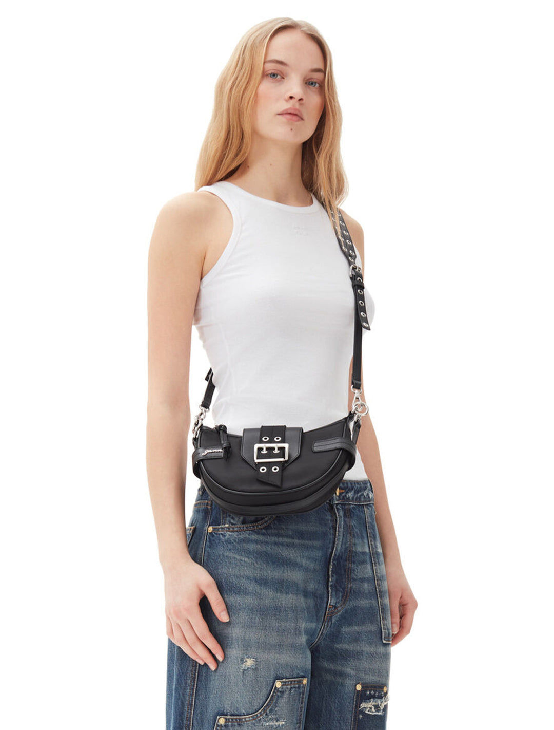 Model wearing GANNI's bucky small crossbody bag in black as a crossbody.