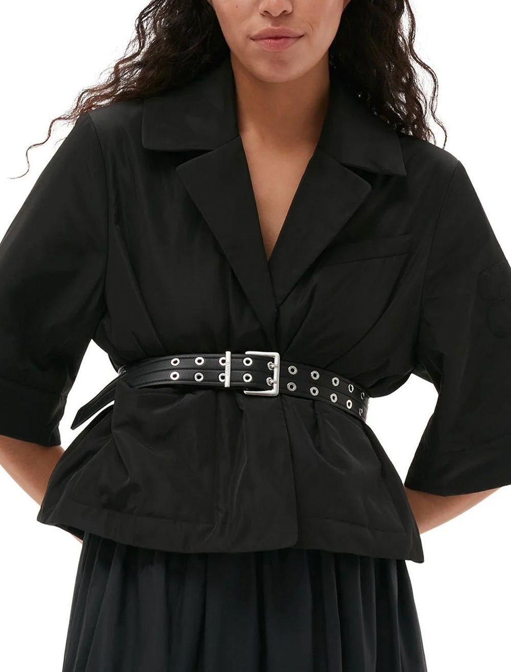 Model wearing GANNI's double eyelet belt in black.