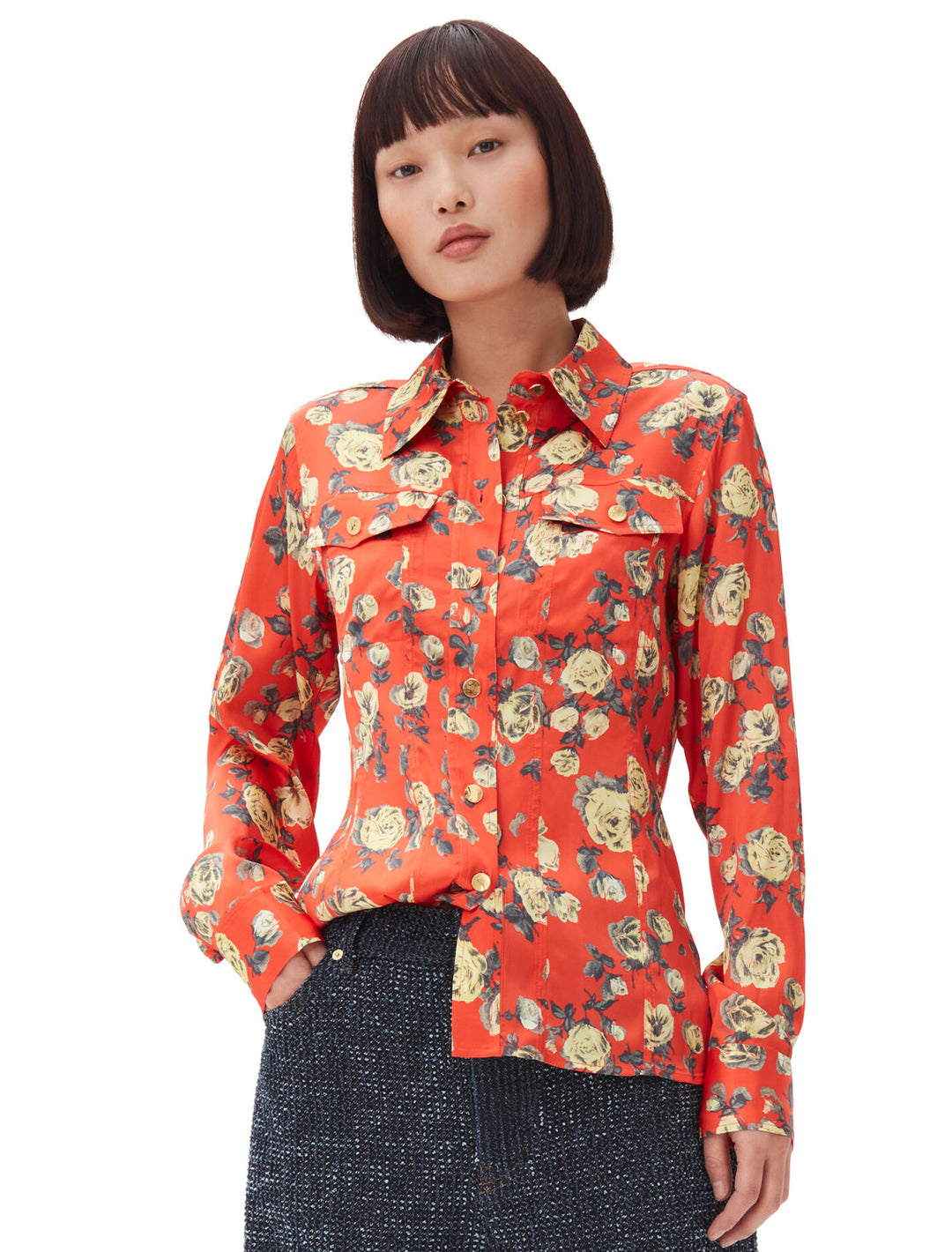 Model wearing GANNI's printed satin shirt in poinciana.