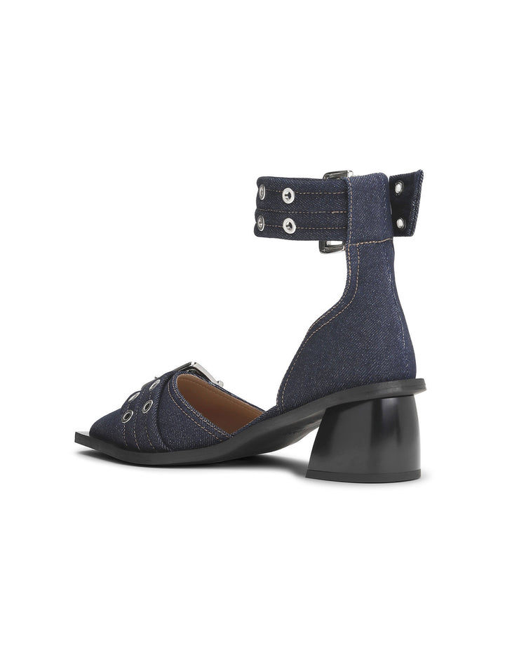 Back angle view of GANNI's feminine buckle open cut pump in denim.