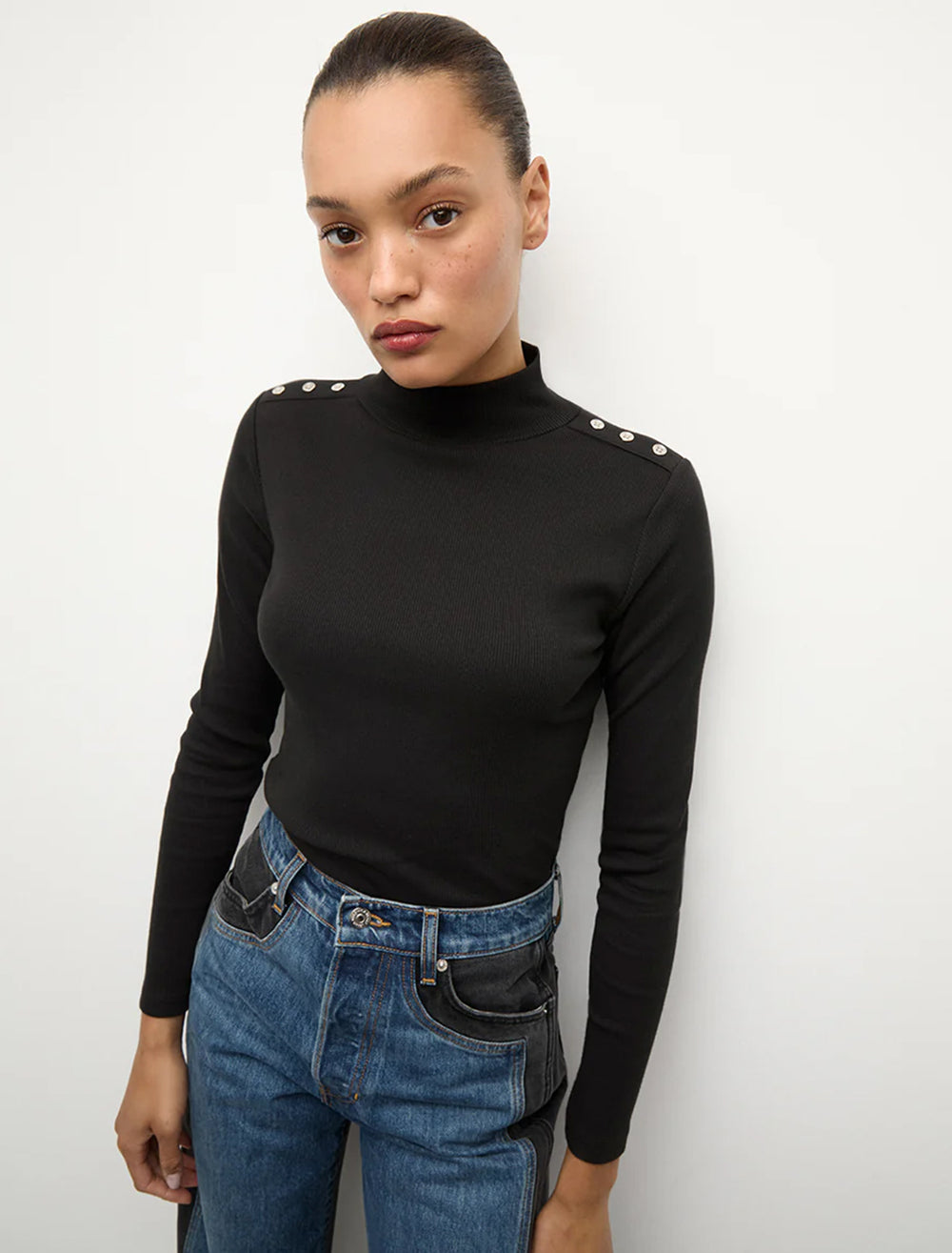 Model wearing Veronica Beard's nate top with buttons in black.