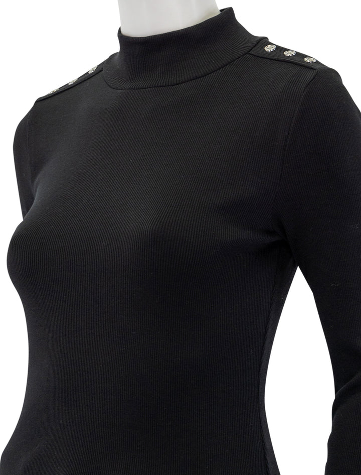 Close-up view of Veronica Beard's nate top with buttons in black.