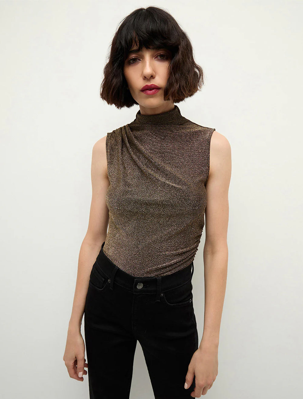 Model wearing Veronica Beard's mylie sleeveless top in antique gold.