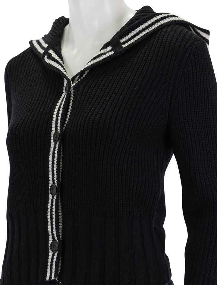 Close-up view of ATM's merino blend hooded cardigan in black and chalk.