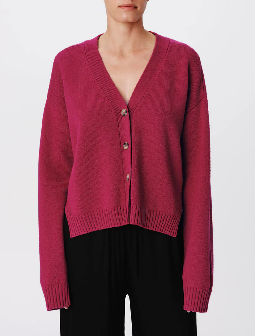 Model wearing ATM's merino blend cardigan in rubellite.