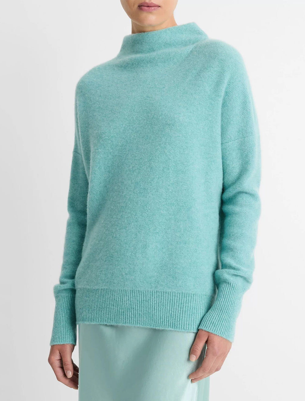 Model wearing Vince's boiled funnel neck pullover in heather aqua gem.