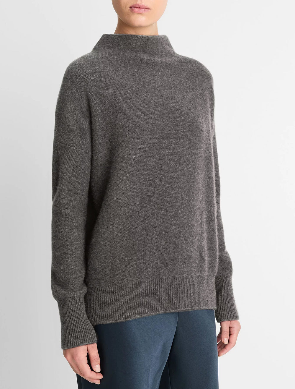 Model wearing Vince's boiled funnel neck pullover in heather graphite.