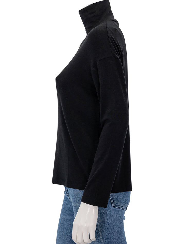 Side view of Vince's relaxed long sleeve turtleneck in black.