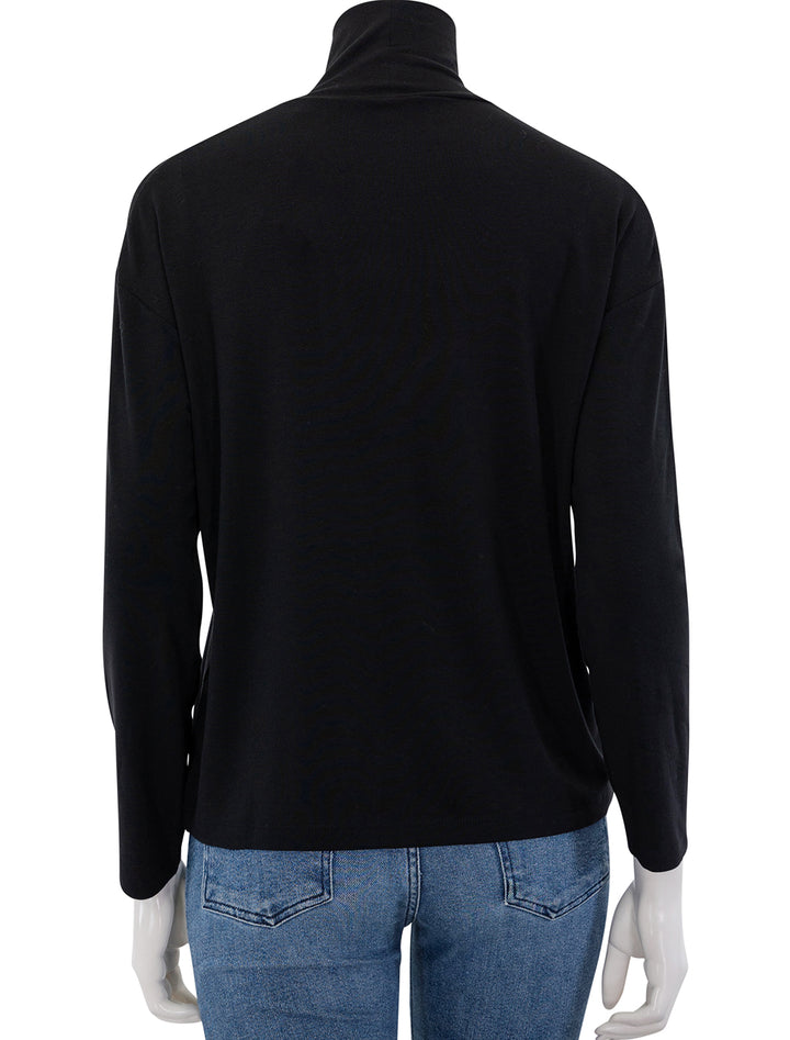 Back view of Vince's relaxed long sleeve turtleneck in black.