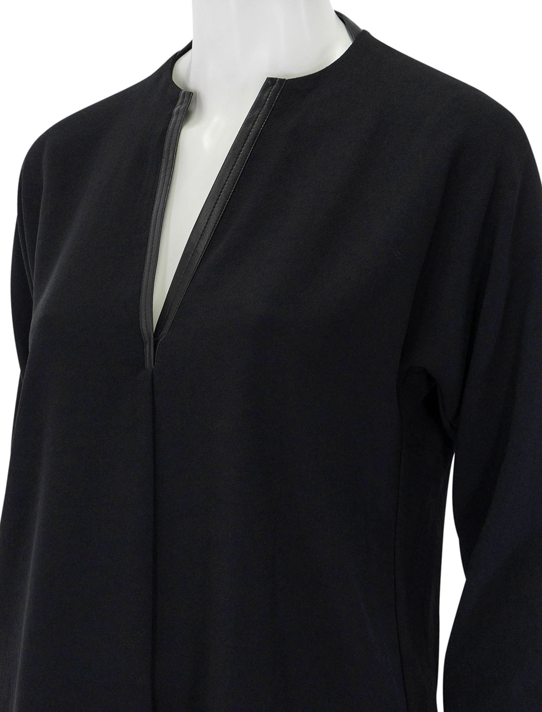 Close-up view of Vince's leather trim dolman sleeve blouse.