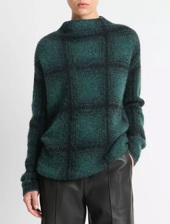 Model wearing Vince's shadow plaid funnel neck pullover in juniper.