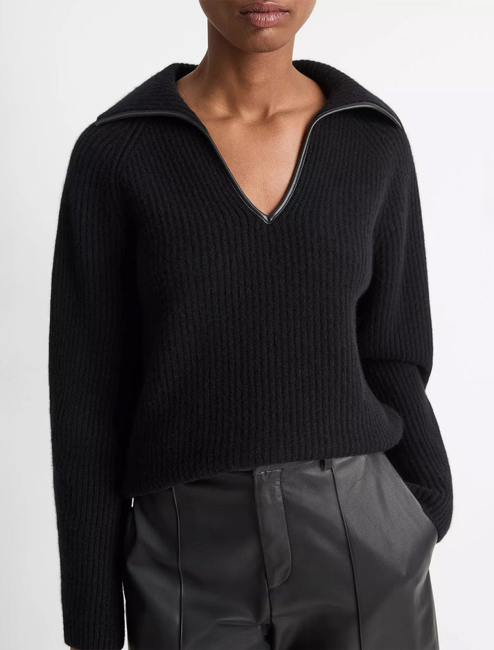 Model wearing Vince's leather trim ribbed polo pullover in black.