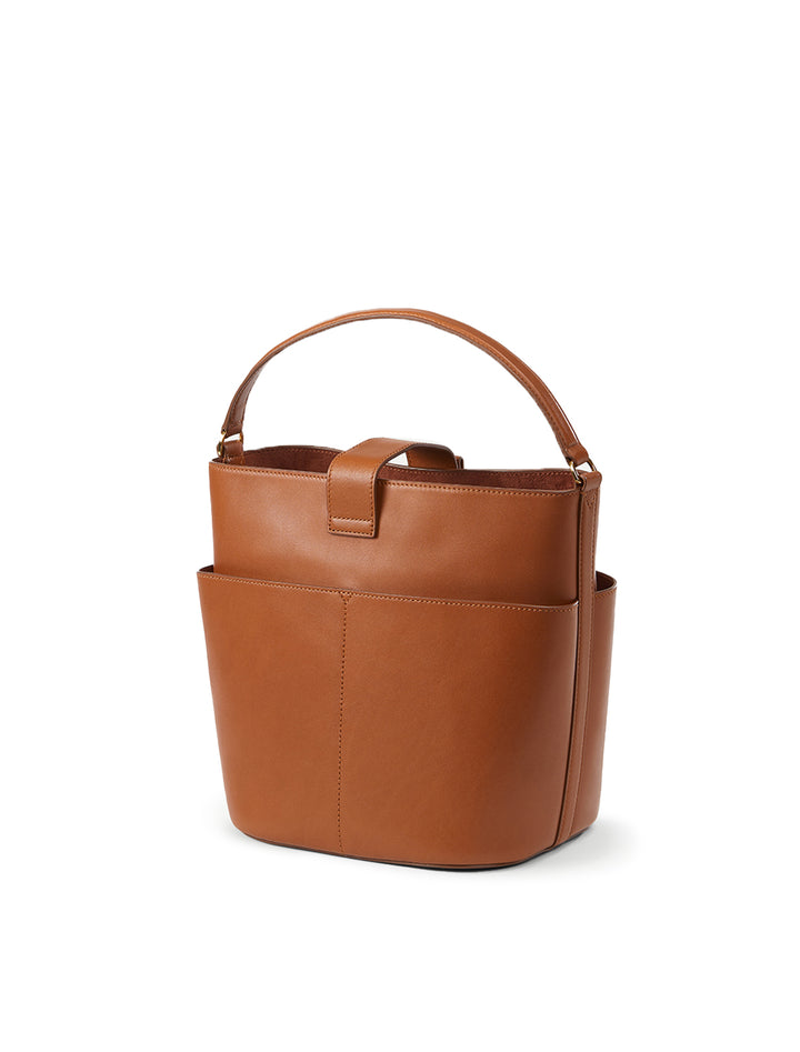 Back angle view of Veronica Beard's the small crest lock bucket bag in hazelwood.