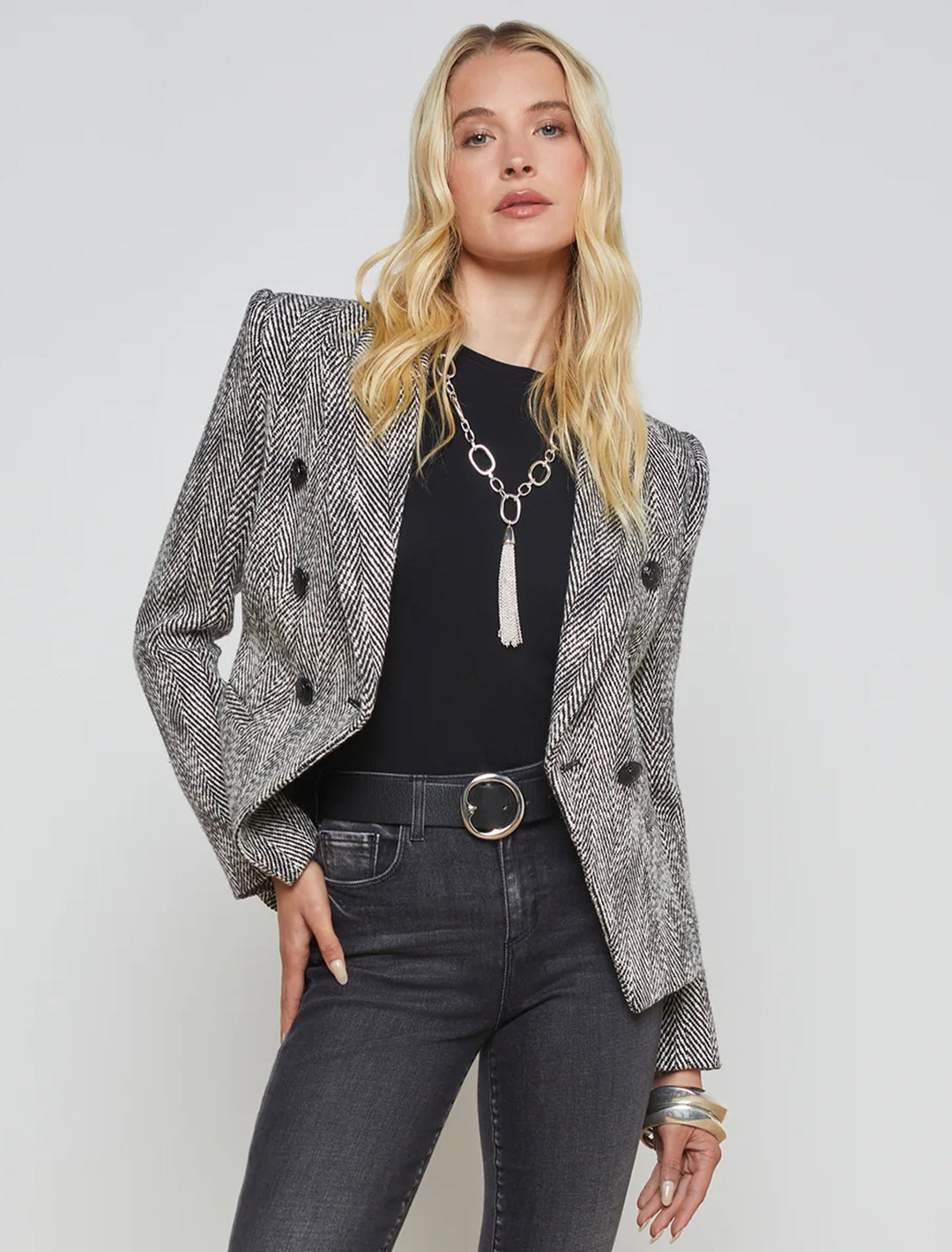 Model wearing L'Agence's marie double breasted blazer in black and white tweed.