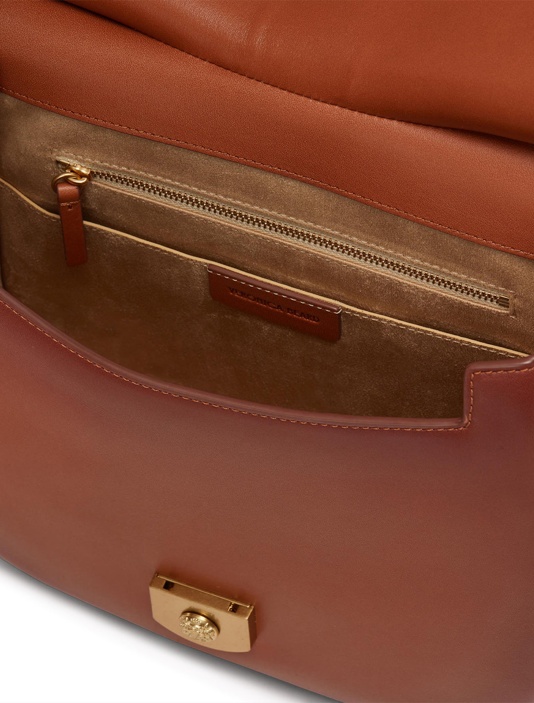 Close-up inside view of Veronica Beard's the crest lock messenger bag in burnished hazelwood.