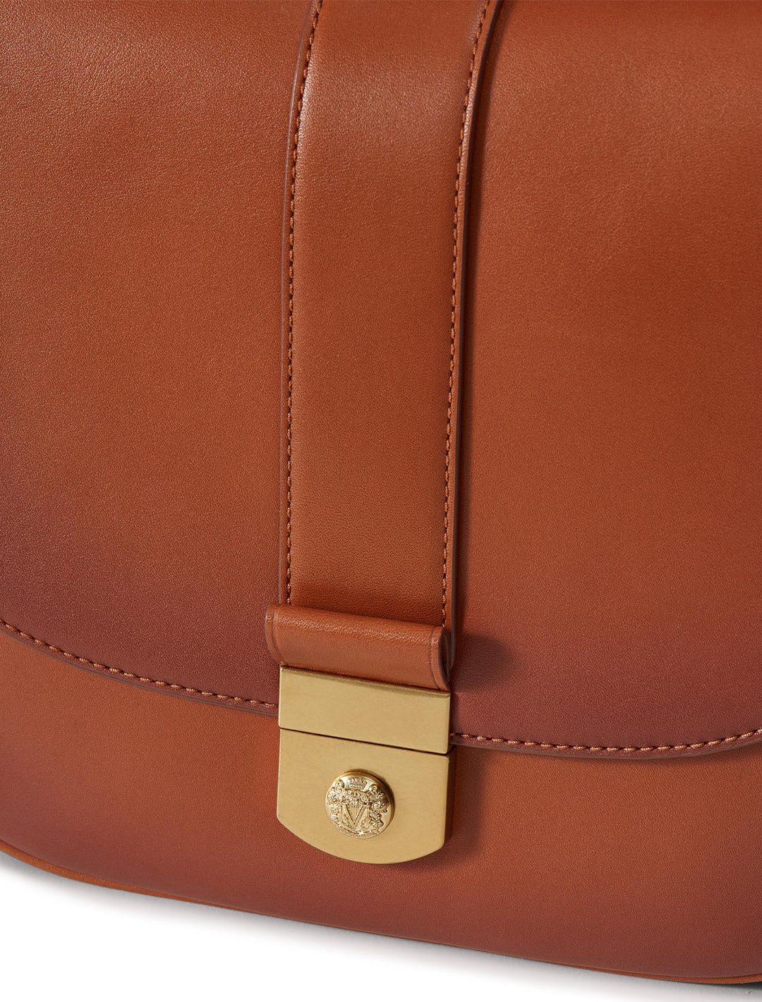 Close-up view of Veronica Beard's the crest lock messenger bag in burnished hazelwood.