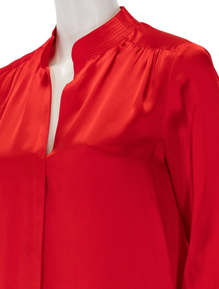 Close-up view of L'agence's bianca band collar blouse in lava red.