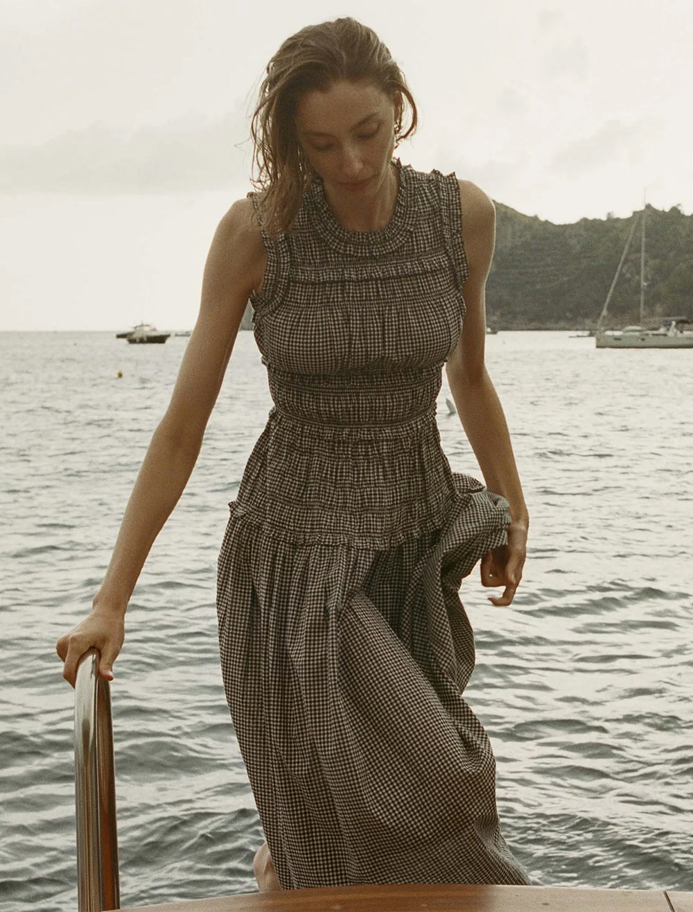 Model wearing DOEN's mallory dress in la maddalena gingham.