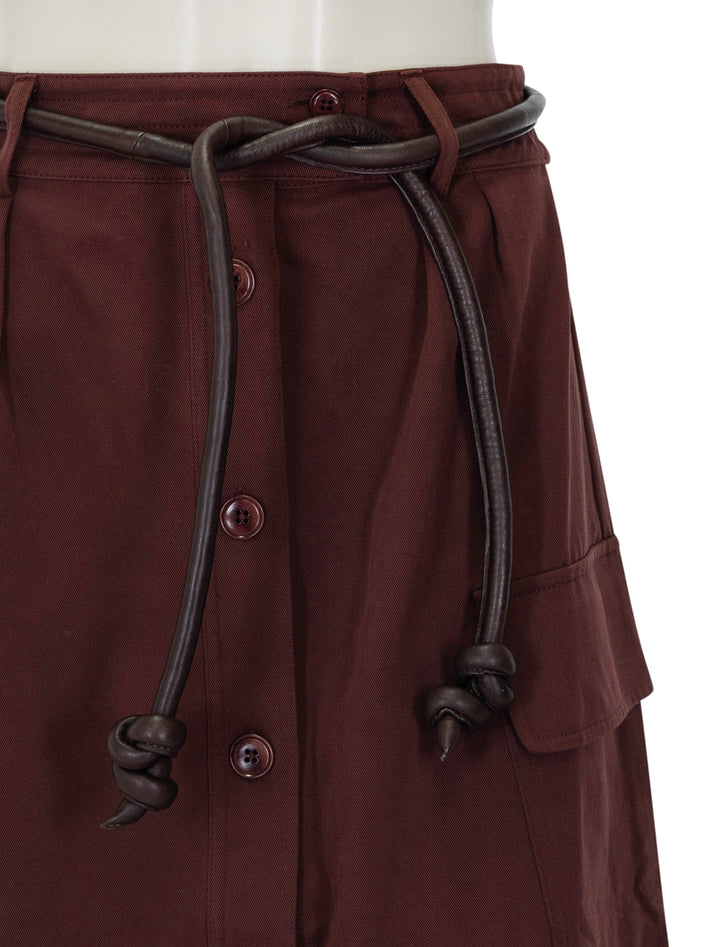 Close-up view of Sea NY's kerith belted skirt in burgundy.