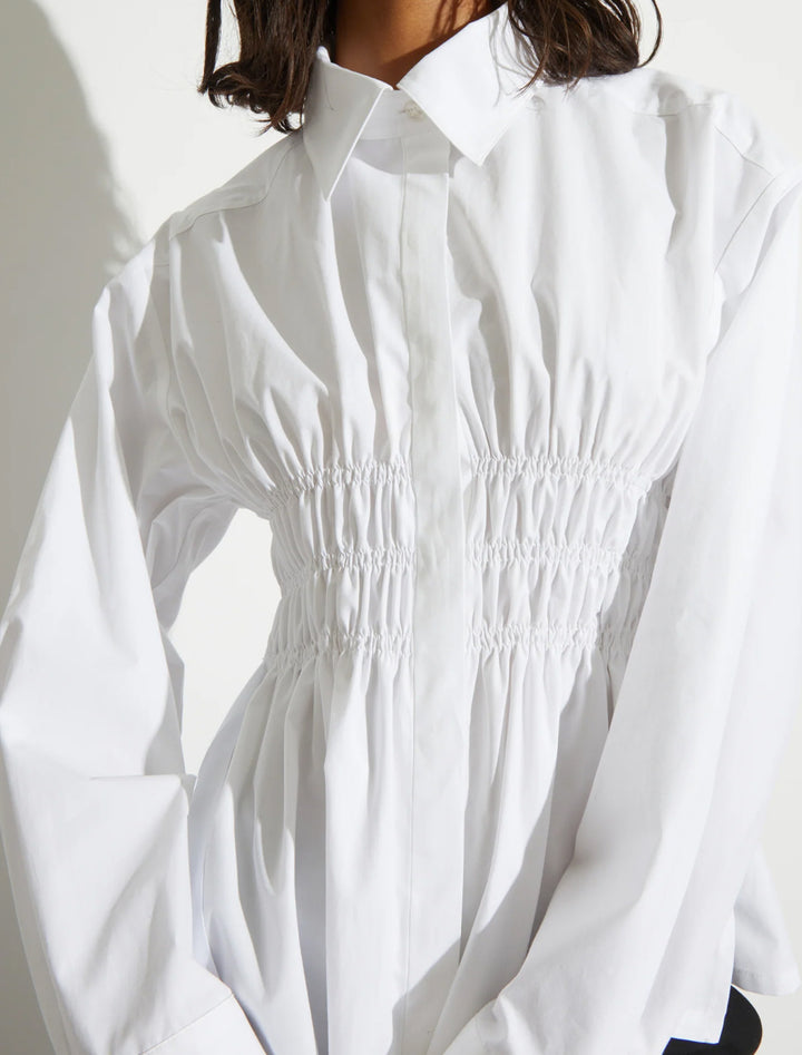 Model wearing Saint Art's yvonne ruched front-tie blouse in white.