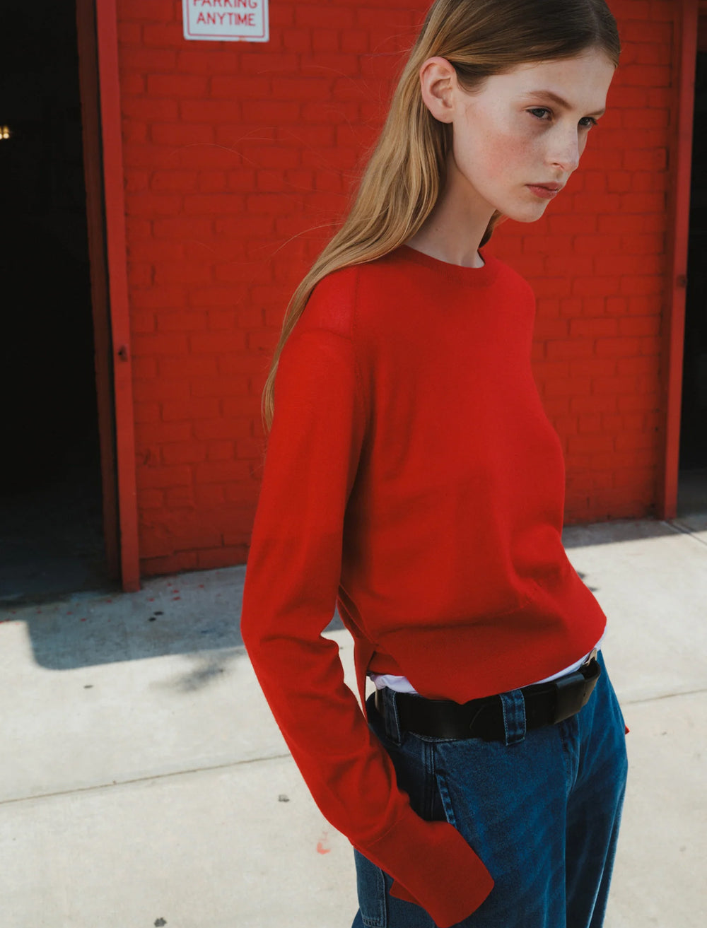 Model wearing Saint Art's elodie layered crewneck in tomato.