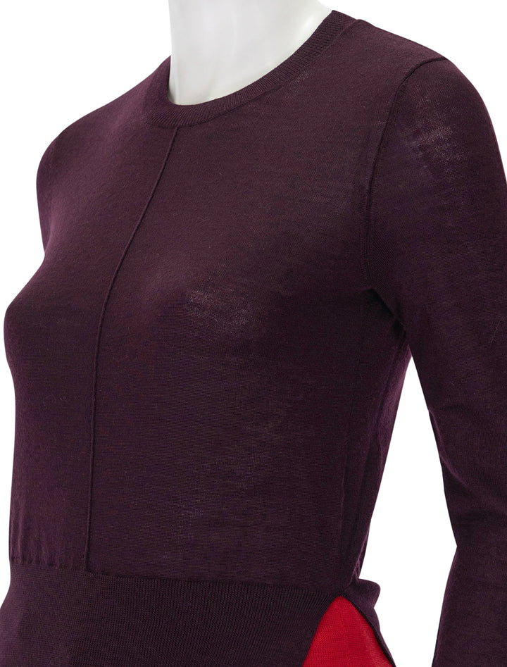 Close-up view of Saint Art's myra layered sweater in burgundy and tomato.