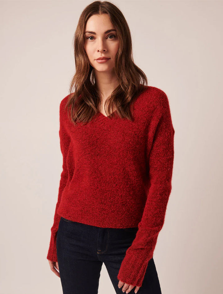 Model wearing  Line's aubrey vneck pullover in merlot.