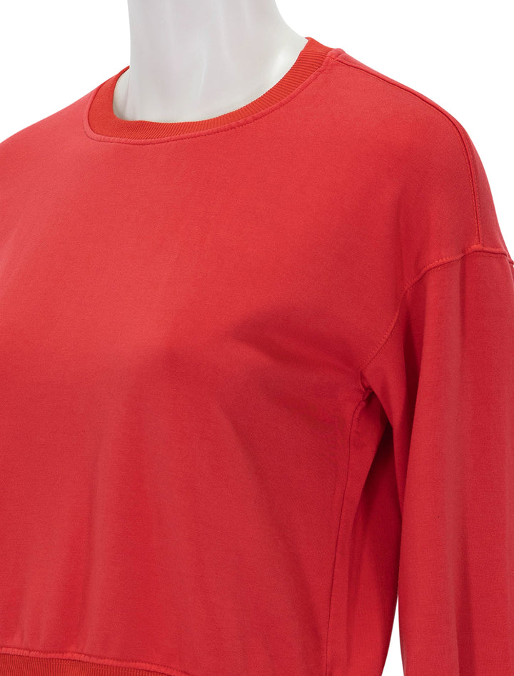 Close-up view of Stateside's softest fleece cropped pleated sleeve sweatshirt in sumo red.