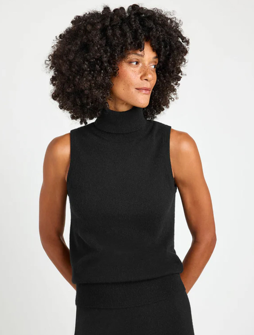 Model wearing Splendid's tori cashmere turtleneck in black.