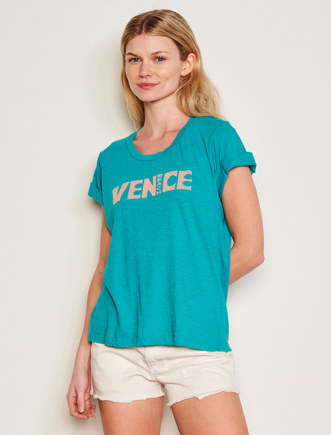 Model wearing Sundry's venice beach rolled sleeve tee in intense teal.