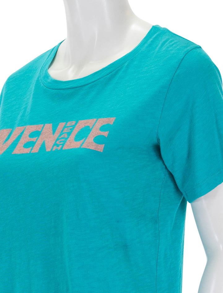 Close-up view of Sundry's venice beach rolled sleeve tee in intense teal.