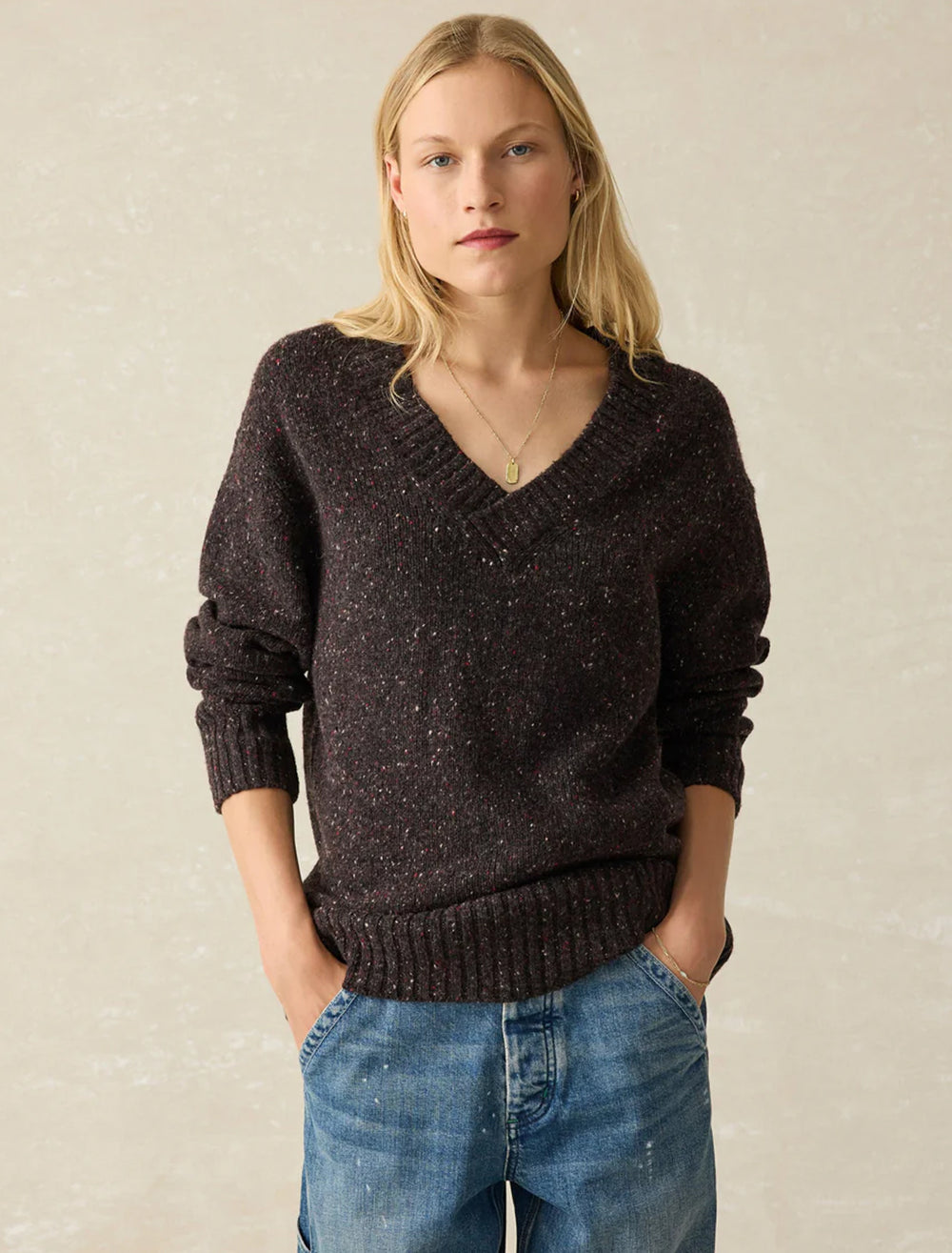 Model wearing Faherty's driftwood donegal sweater in blackberry.