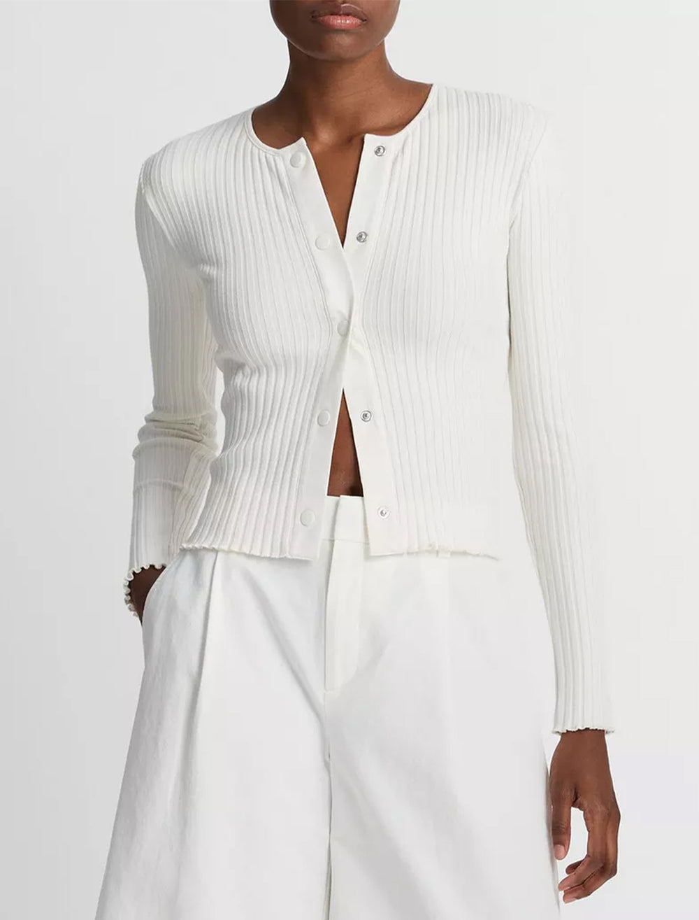 Model wearing Vince's ribbed cardigan in off white.