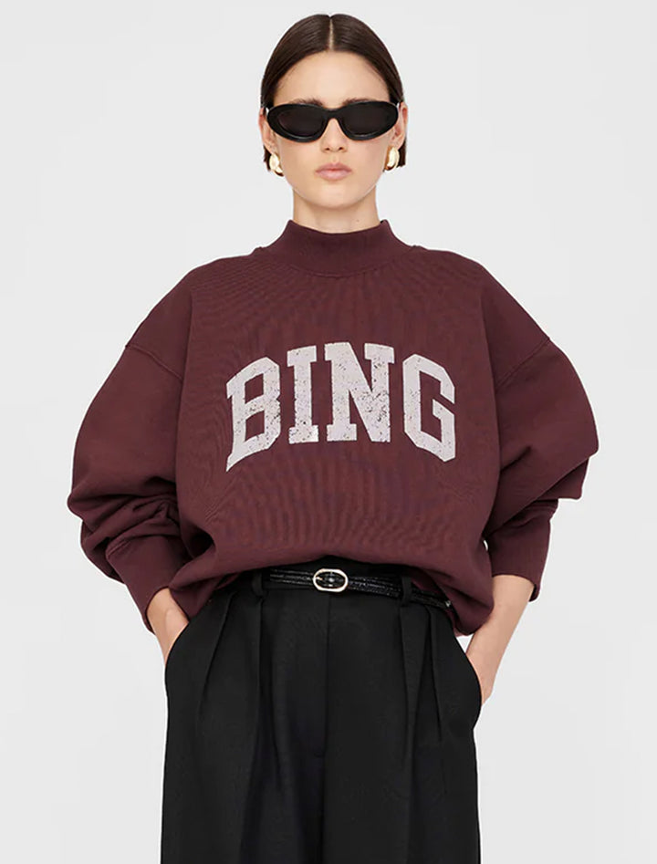 Model wearing Anine Bing's bradie bing sweatshirt in deep burgundy.