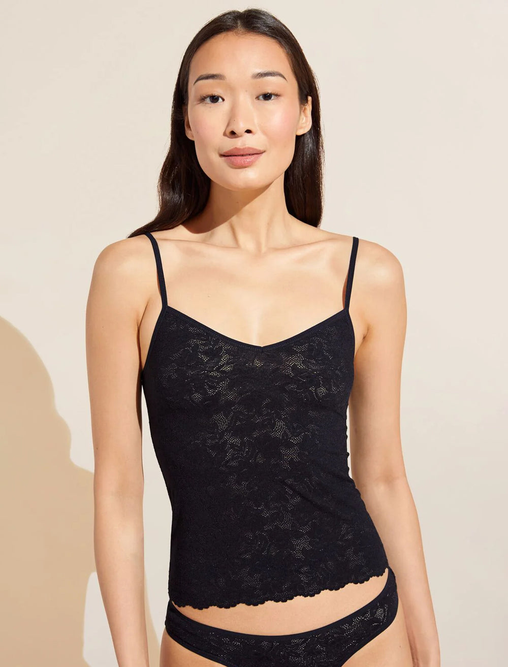 Model wearing Eberjey's soft stretch recycled lace cami in black.