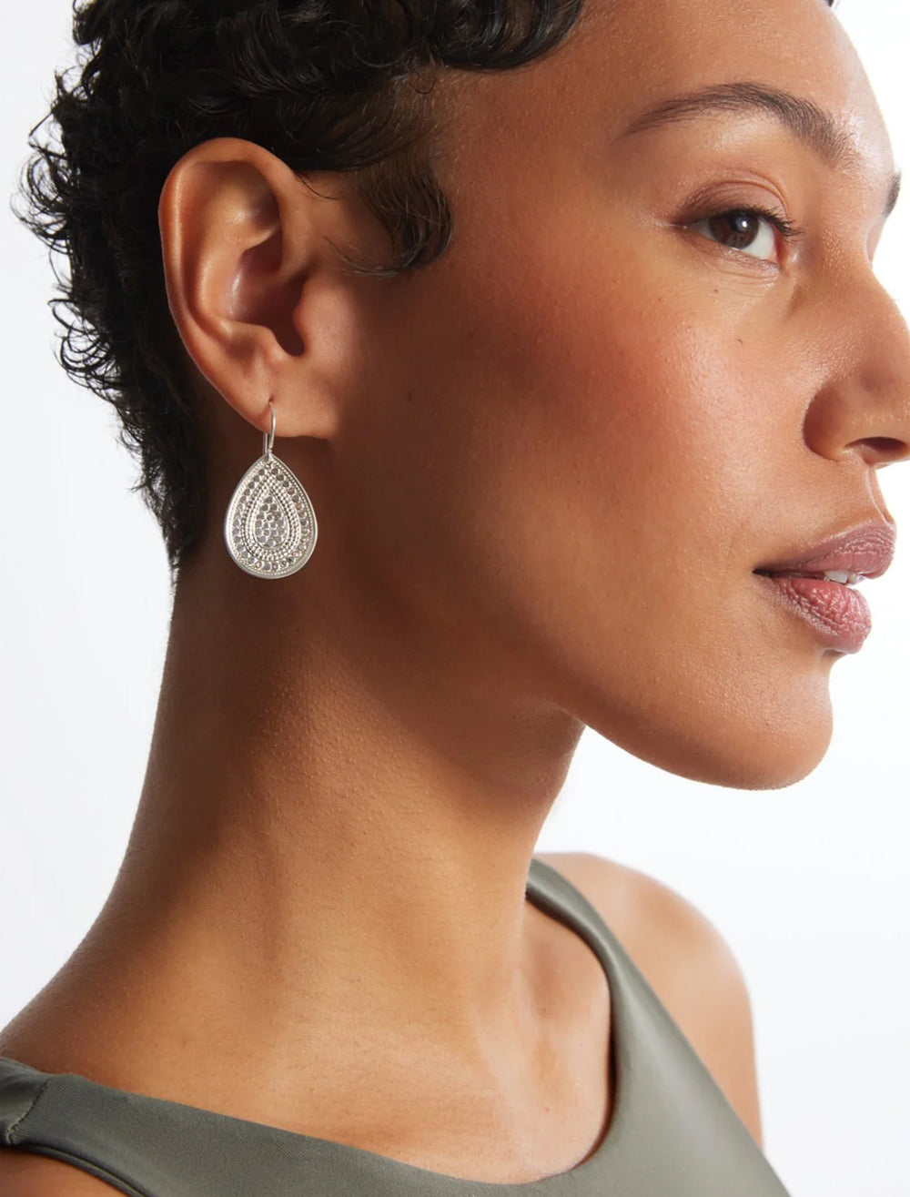 Model wearing Anna Beck's beaded teardrop earrings in silver.