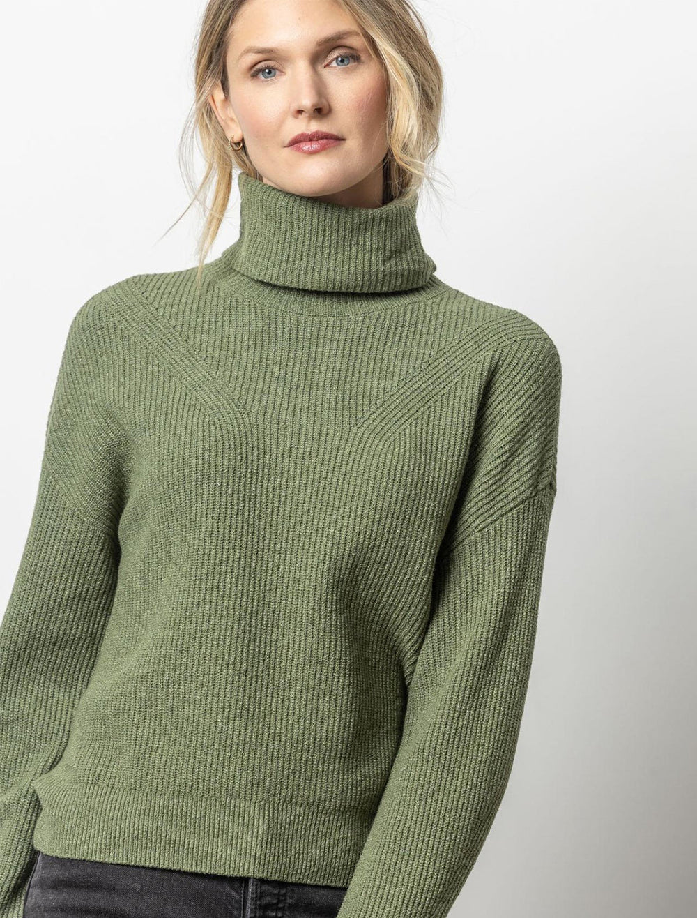 Model wearing Lilla P.'s relaxed rib turtleneck sweater in wintergreen.