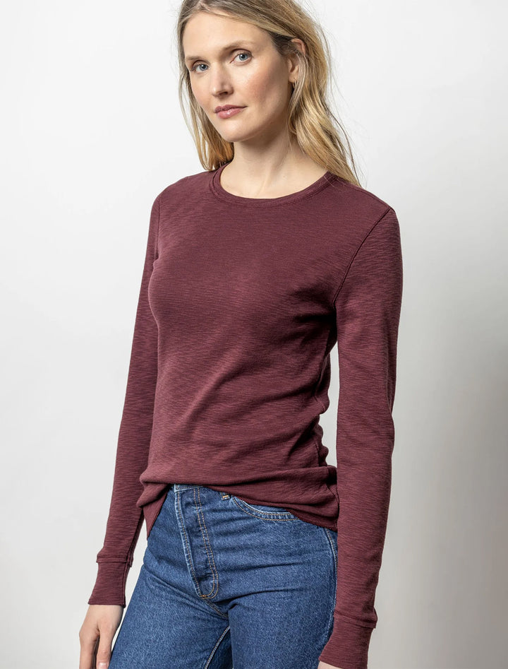 Model wearing Lilla P.'s long sleeve raw edge crew in wine.