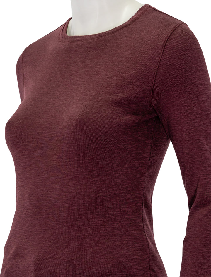 Close-up view of Lilla P.'s long sleeve raw edge crew in wine.