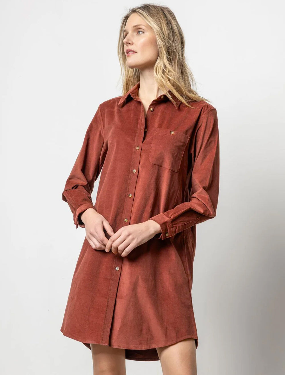 Model wearing Lilla P.'s corduroy shirt dress in brandy.