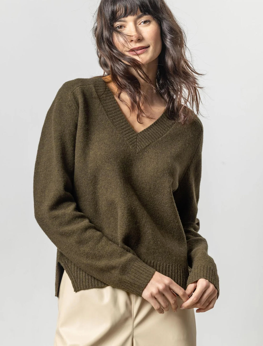 Model wearing Lilla P.'s felted easy v-neck sweater in deep pine.