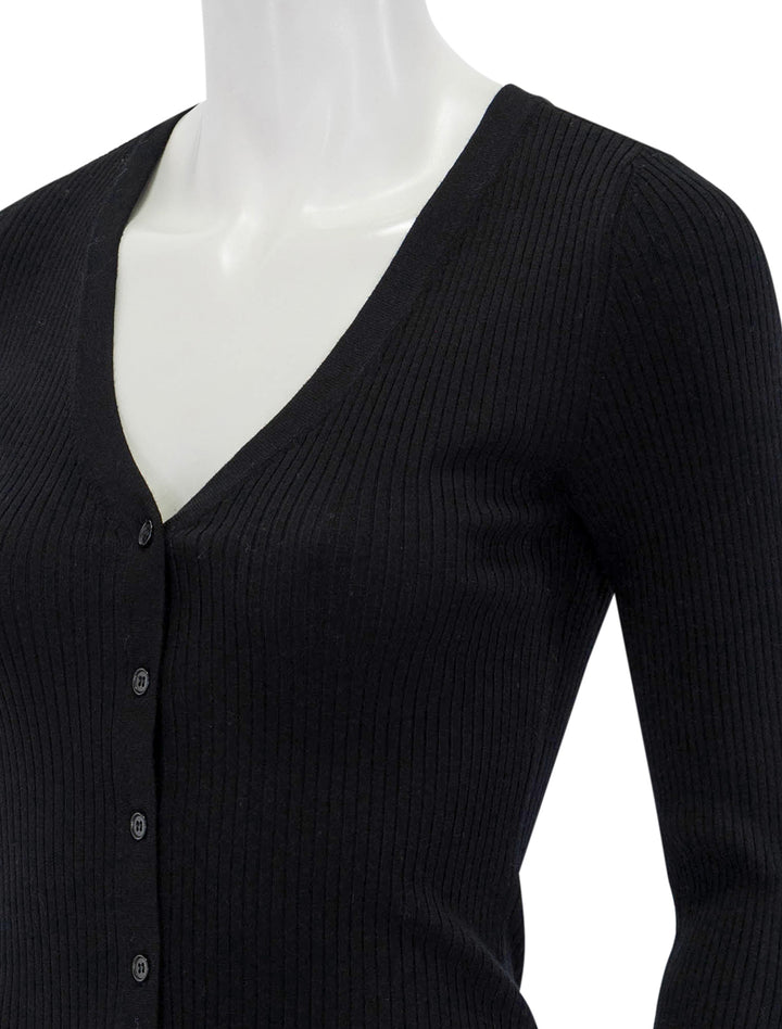 Close-up view of Lilla P.'s ribbed cardigan sweater in black.