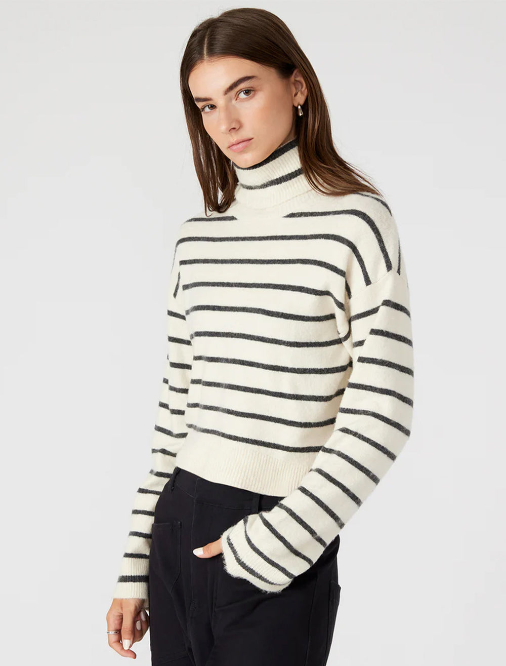 Model wearing Steve Madden's narsha sweater in ivory stripe.